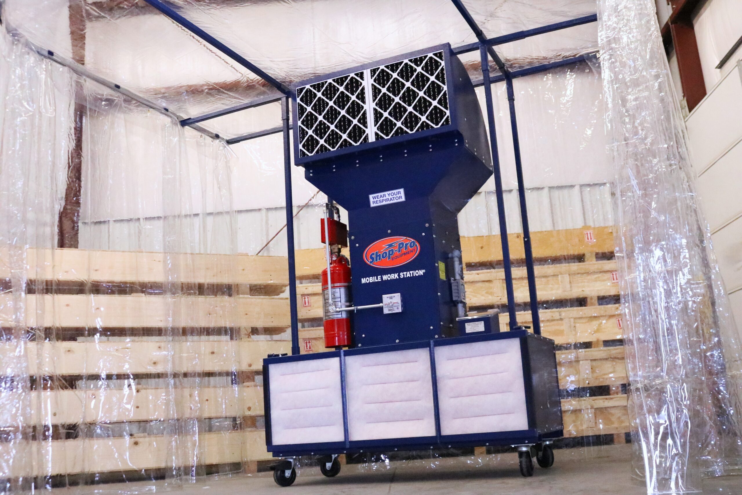 Mobile paint booth with fire suppression in a warehouse setting.