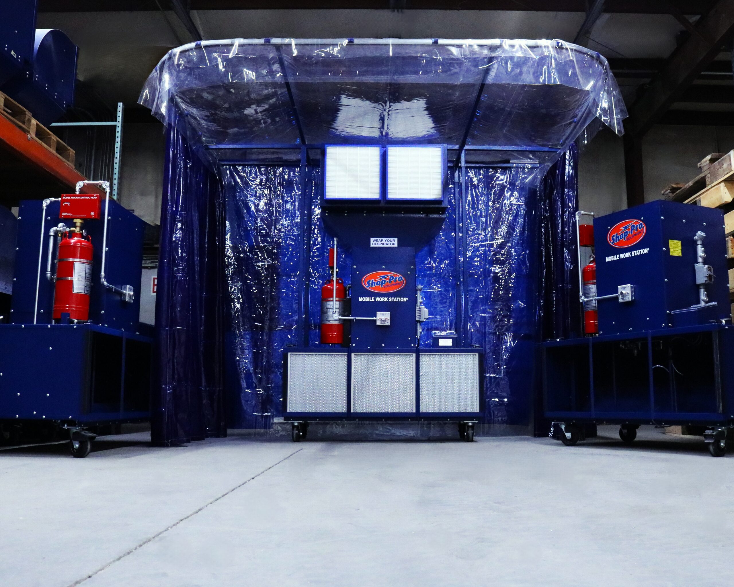 Mobile Weld Station setup with UV blocking curtains and weld specific filters. Background includes other various models in a shop environment.